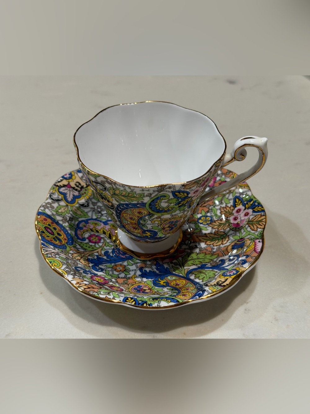 Vibrant Paisley Porcelain Teacup & Saucer with Gold Trim